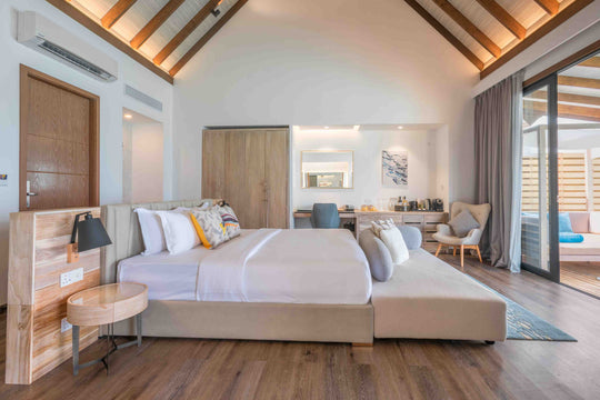 Fushifaru Maldives, Lhaviyani Atoll — villa bedroom beneath a timber ceiling