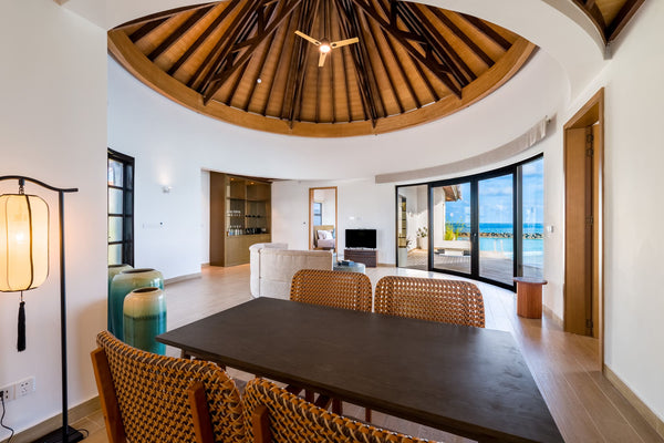 A villa living and dining area at NOOE Maldives Kunaavashi.