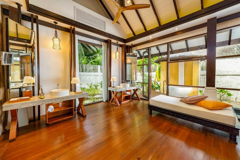 A villa bathroom at OZEN RESERVE Bolifushi, twin basins on a timber vanity with lanterns above