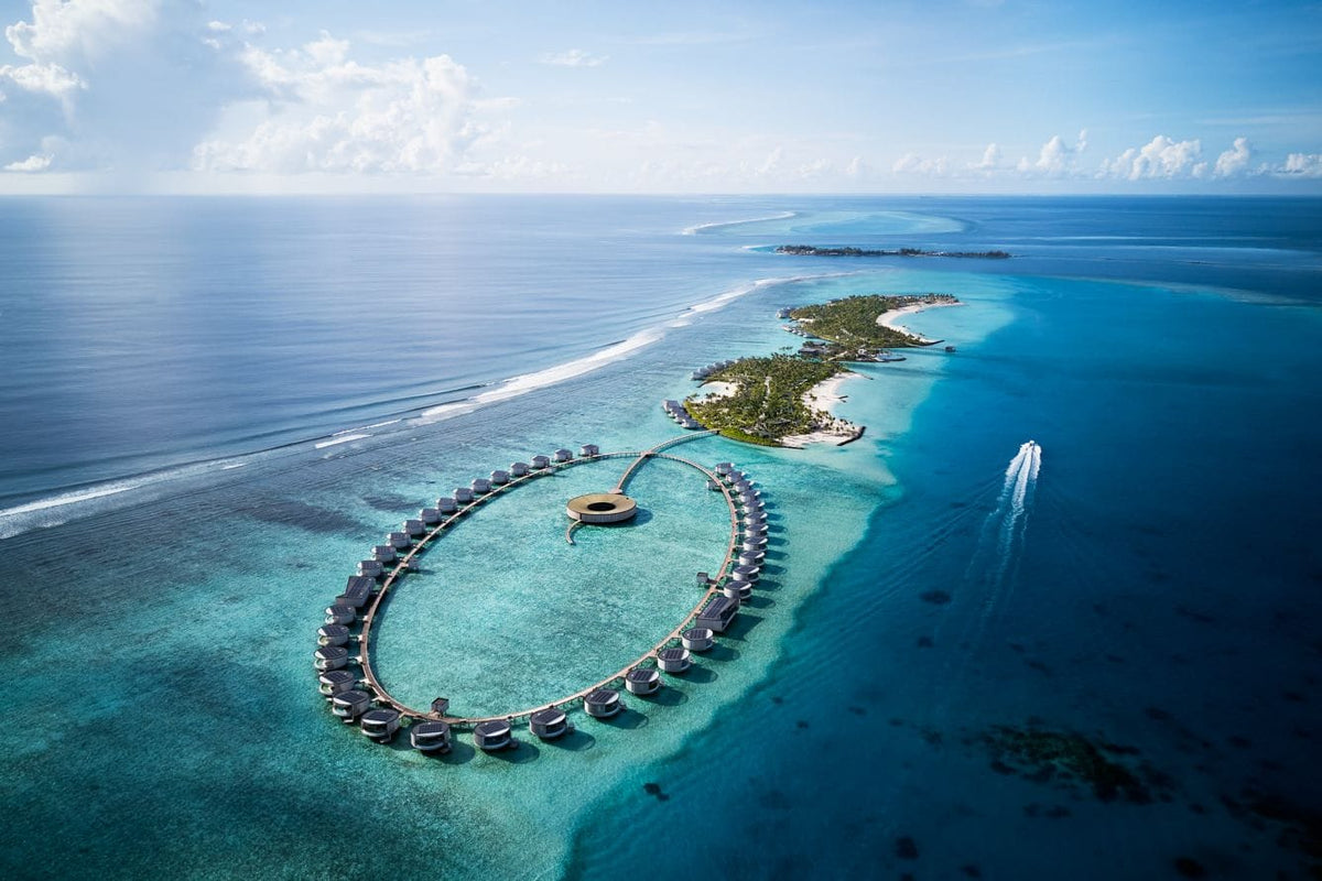 The Ritz-Carlton Maldives, Fari Islands from the air, the circular overwater building standing in a pale lagoon