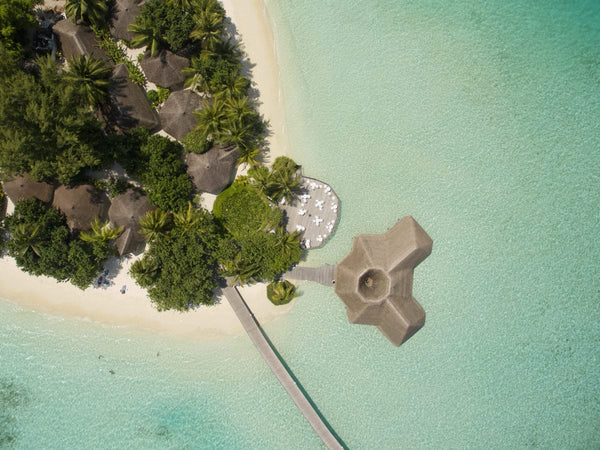 Overhead view of the jetty and overwater pavilion at Safari Island Resort & Spa