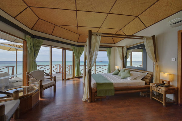 Interior of a water bungalow at Safari Island looking out across the lagoon