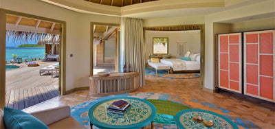 The living room of an Ocean House with Private Pool at The Nautilus Maldives, looking through to the bedroom.