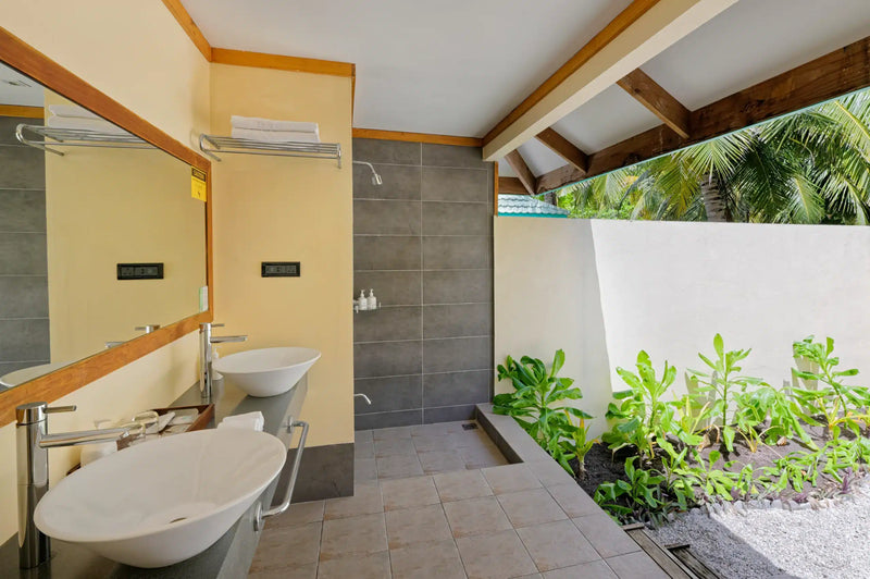 The outdoor bathroom of a Sunrise Villa at Canareef Resort Maldives