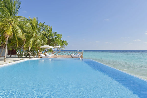 The infinity pool looking out to the lagoon at Thulhagiri Island Resort