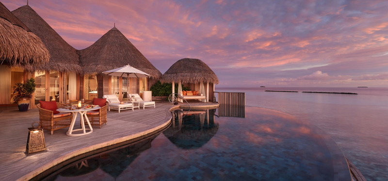 The deck of an Ocean Residence with Private Pool at The Nautilus Maldives at dusk.