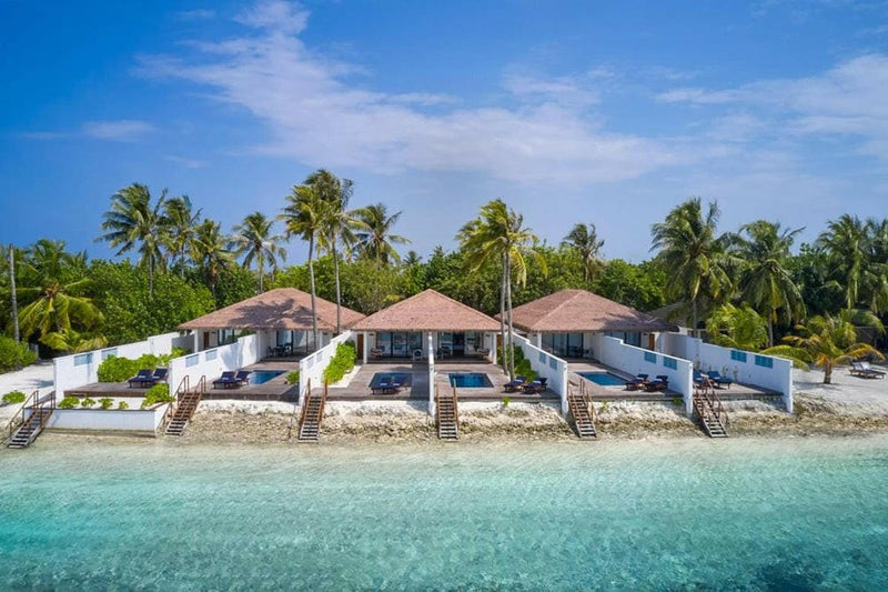 Pool villas at Villa Nautica from the water, private pools and loungers set right on the sand.