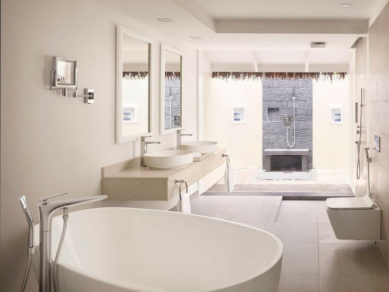 A villa bathroom at Villa Nautica, an oval tub and twin basins lit by shuttered windows.