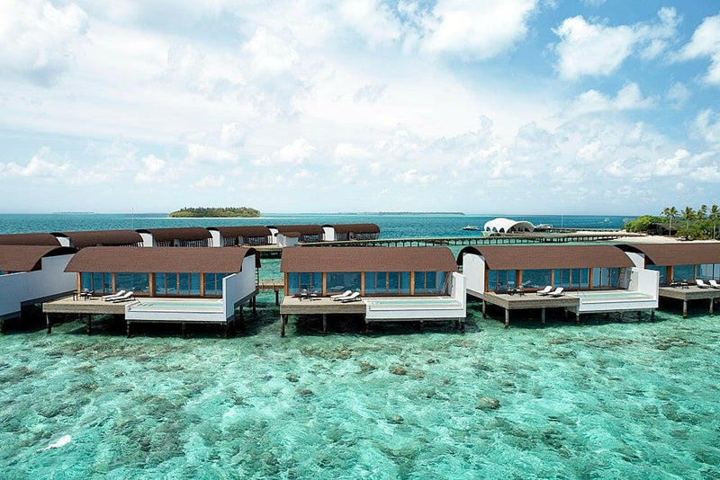 Overwater villas at The Westin Maldives Miriandhoo, each with a pool above clear coral shallows.