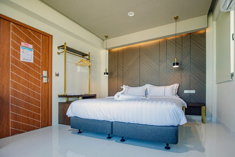 Room at Royal Villa with a double bed and wood-panelled wall