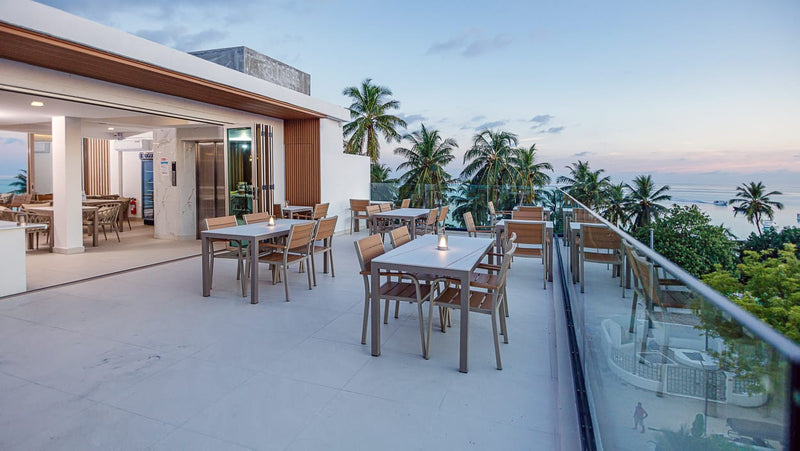 Rooftop terrace with dining tables looking out to sea at Royal Villa, Fulidhoo