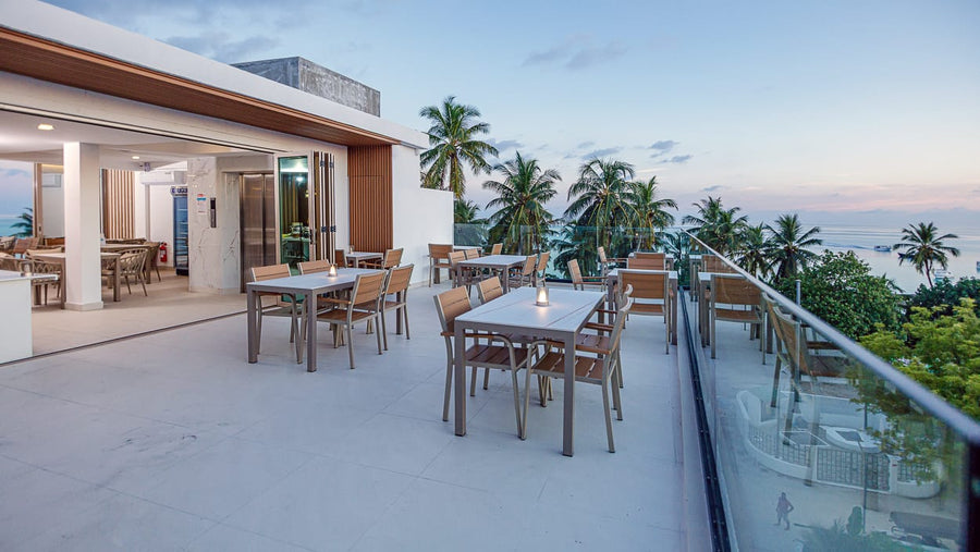 Rooftop terrace with dining tables looking out to sea at Royal Villa, Fulidhoo