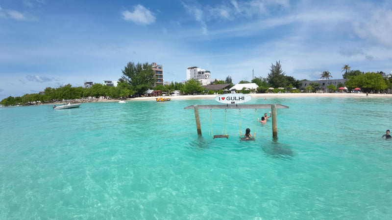 Swings in the turquoise lagoon off the Gulhi beach