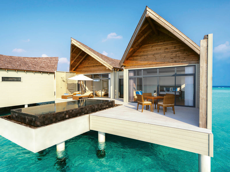 An Overwater Pool Villa Sunrise at Kuredhivaru Resort & Spa Maldives.