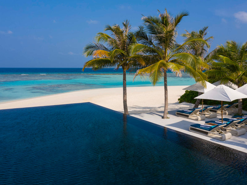 A swimming pool at Kuredhivaru Resort & Spa Maldives.