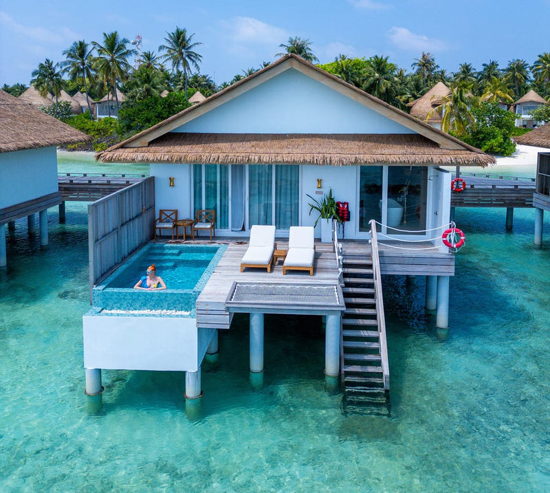 A Sunset Water Villa with Pool at Bandos Maldives, with steps down into the lagoon.