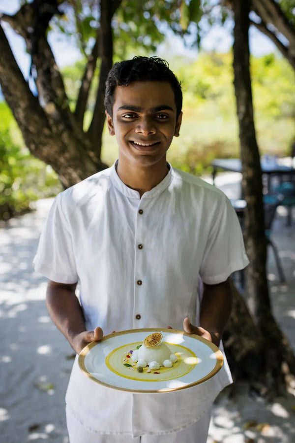 A waiter with dessert at Faru, Niva Dhigali Maldives.