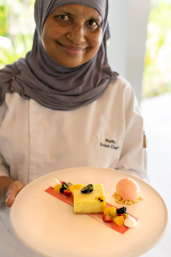 A chef plating cheesecake at Jade, Niva Dhigali Maldives.