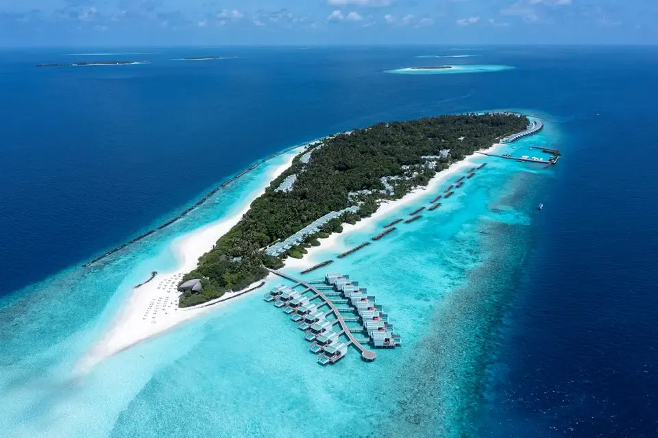 Niva Dhigali Maldives from the air, the whole island ringed by white sand and reef.