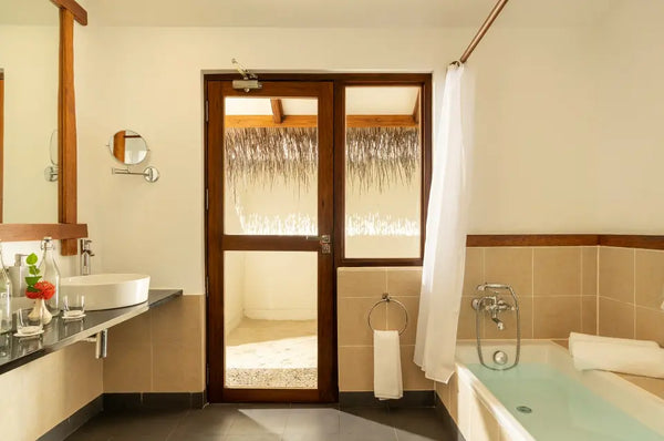 The bathroom of a Deluxe Beach Villa at Niva Kuramathi Maldives.