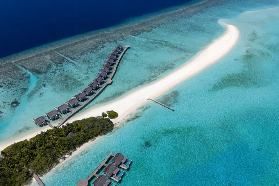Niva Kuramathi Maldives from the air, the sandbank and overwater villa row.