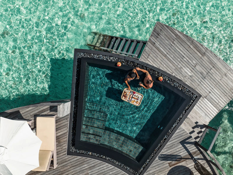 Constance Halaveli, North Ari Atoll: a Water Villa's private plunge pool seen from above, set into the timber deck over the lagoon