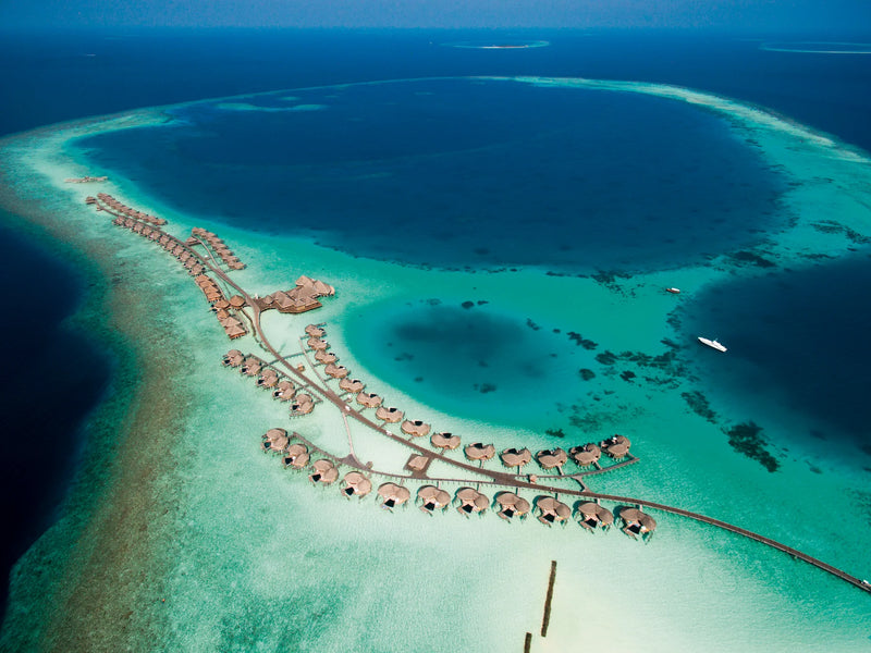 Constance Halaveli, North Ari Atoll: aerial view of the curving jetties of water villas over the turquoise lagoon