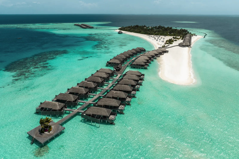 Constance Moofushi, South Ari Atoll: aerial view of the water villa jetty curving out from a white sandbank