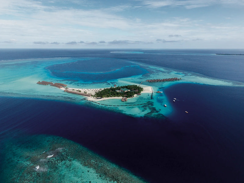 Constance Moofushi, South Ari Atoll: the island seen from the air, set in the open blue of the atoll