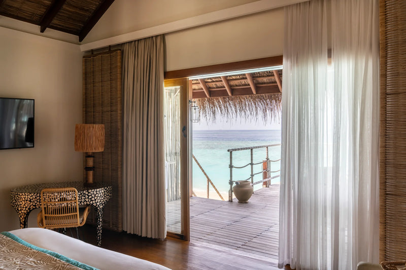 Constance Moofushi, South Ari Atoll: view from inside a Sand Villa through open doors to the deck and the lagoon