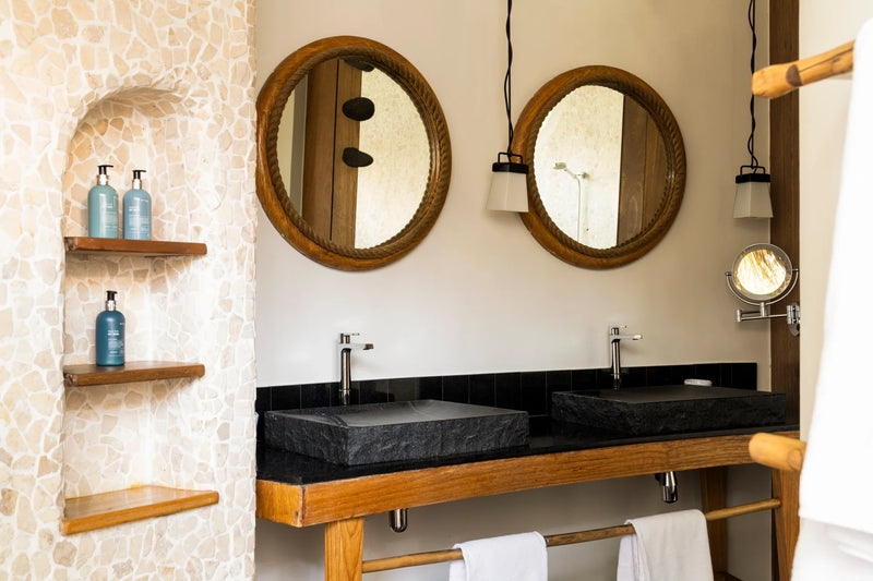 Constance Moofushi, South Ari Atoll: Beach Villa bathroom with twin stone basins and round timber-framed mirrors