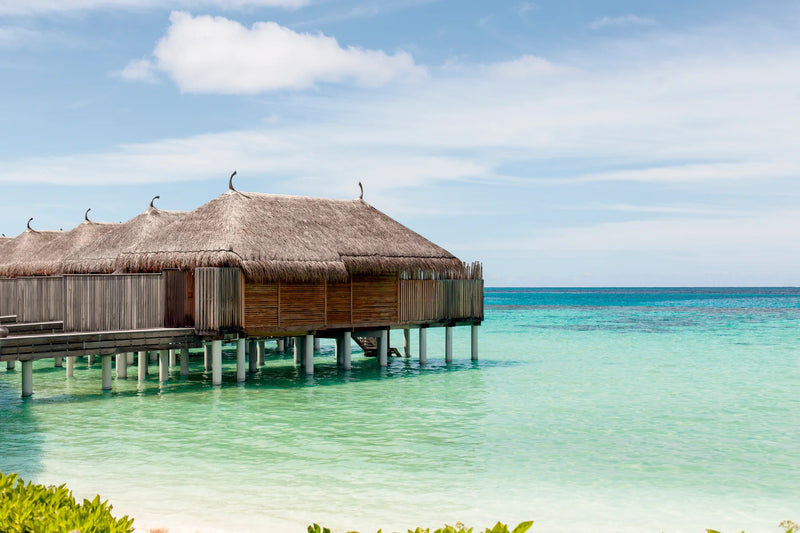Constance Moofushi, South Ari Atoll: thatched Water Villas on stilts over the shallow turquoise lagoon