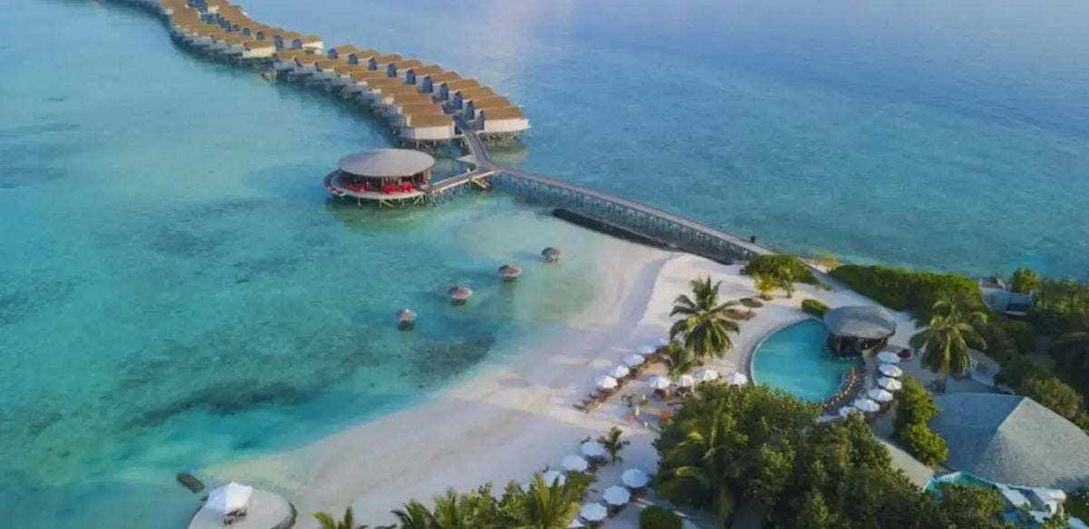 Centara Ras Fushi Resort & Spa Maldives from the air, the jetty, beach and lagoon.