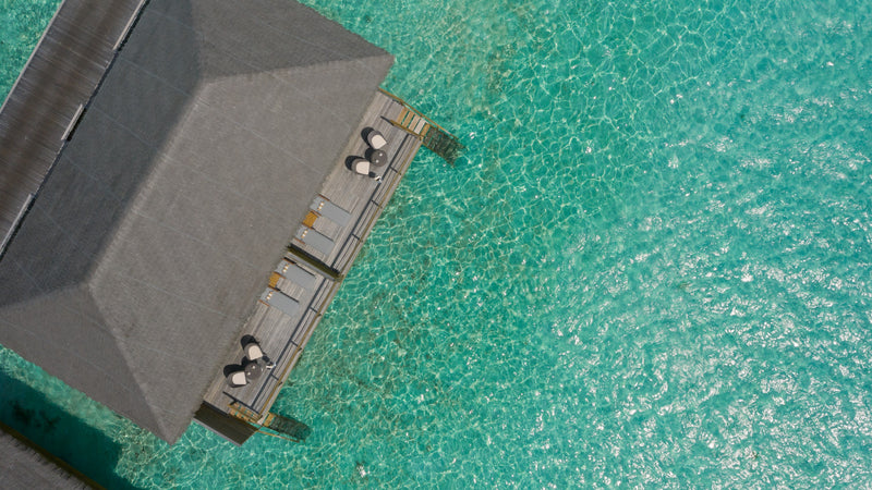 A jetty over the shallows at Cocoon Maldives.
