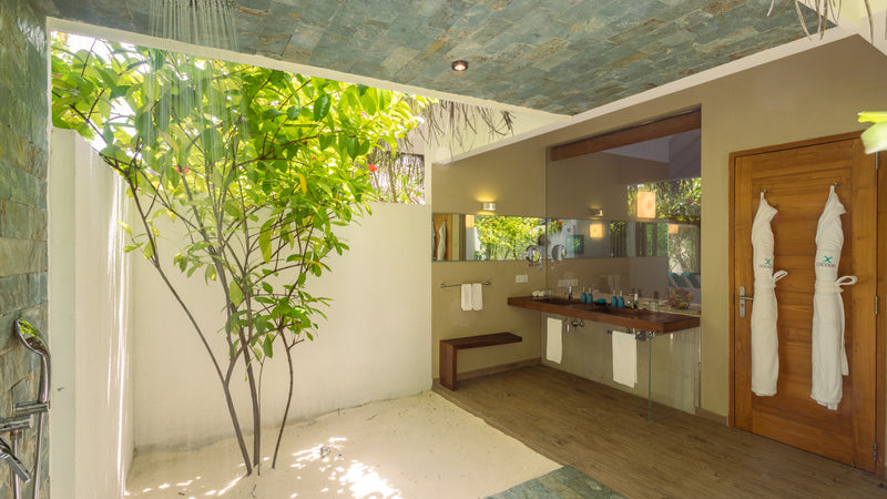 A bathroom open to the garden at Cocoon Maldives.