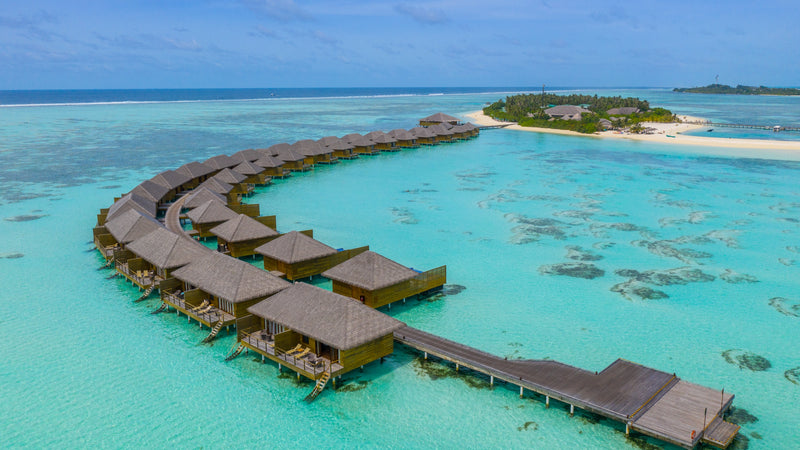 The overwater villa row at Cocoon Maldives, curving over the lagoon.