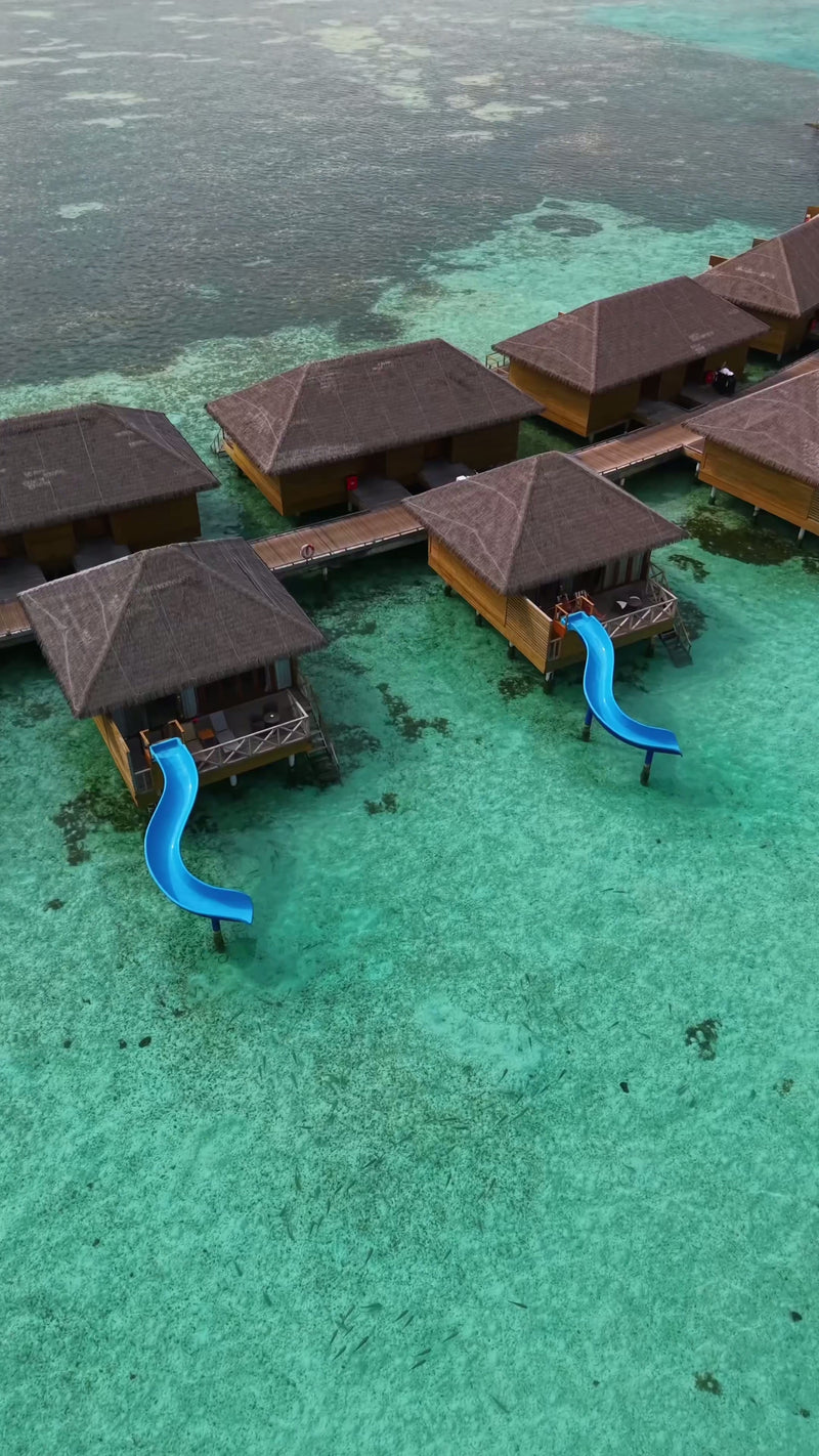 Two overwater villas with water slides at Cocoon Maldives.