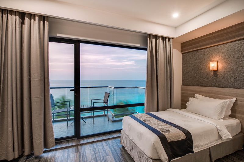 Room at Kaani Grand Seaview with a floor-to-ceiling window onto the sea