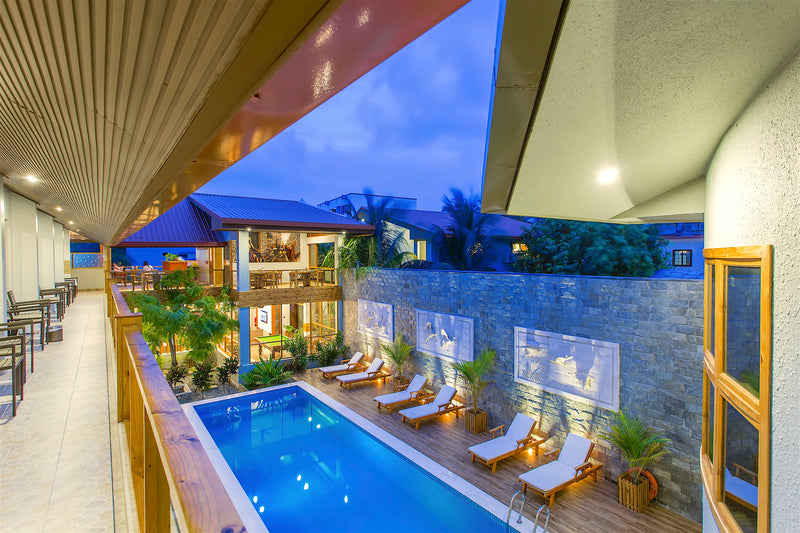 View down onto the pool from an upper walkway at Kaani Village & Spa