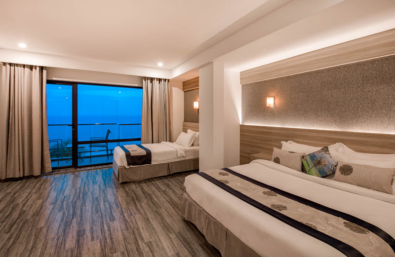 Family sea-view room at Kaani Grand Seaview with two beds and a balcony