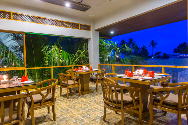 Restaurant at Kaani Village & Spa with tables laid for dinner