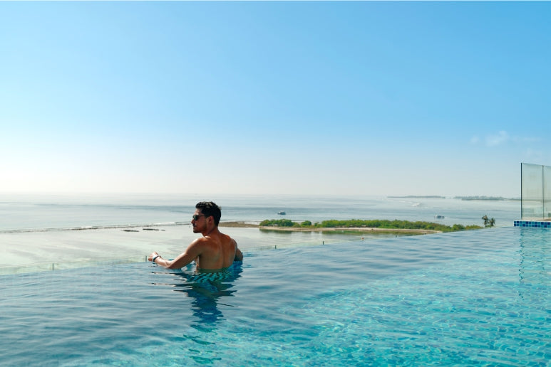 h78 Guraidhoo, South Malé Atoll: a guest in the infinity pool looking out to sea