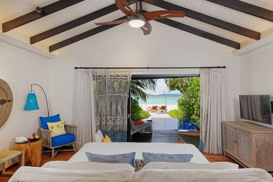 A Beach Pool Villa bedroom at Grand Park Kodhipparu, looking out to its private pool and the ocean