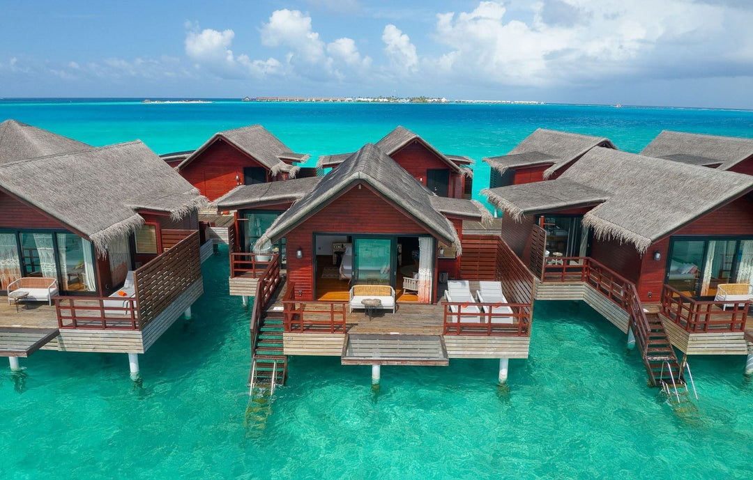 Lagoon Water Villas at Grand Park Kodhipparu, timber villas with decks and steps down into turquoise water