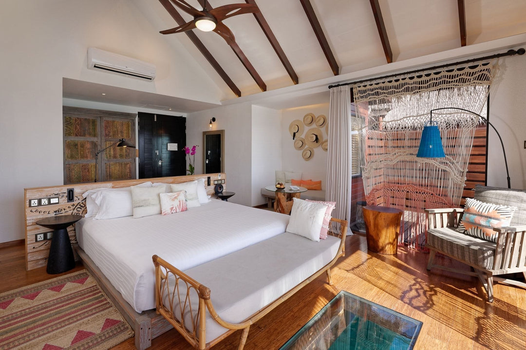 An Ocean Water Villa bedroom at Grand Park Kodhipparu, a large bed and timber furniture