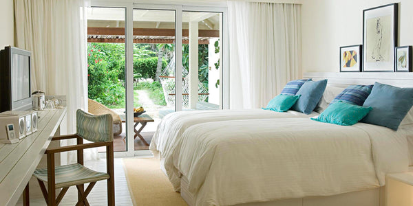 A bedroom opening to the garden at Holiday Inn Resort Kandooma Maldives.
