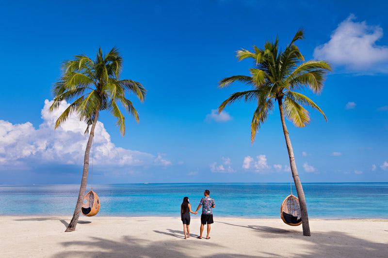Guests walking the beach at Cocoon Maldives.