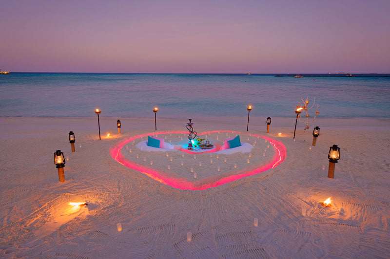 A private dinner set on the beach at You & Me Maldives.