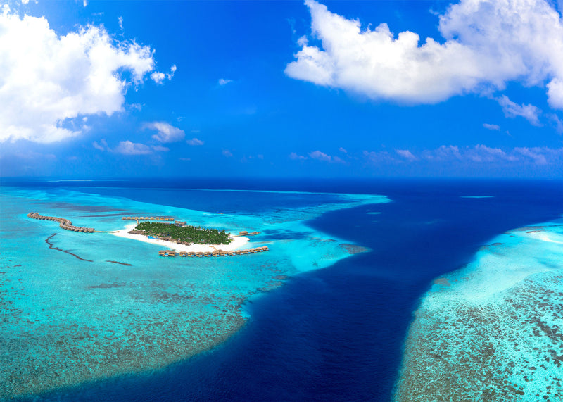 You & Me Maldives from the air, the island on the edge of the reef.