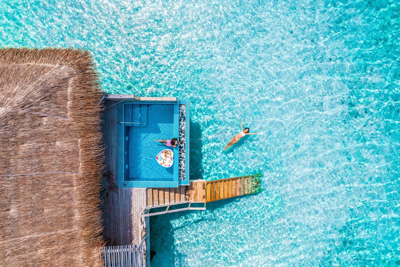 The deck and pool of an overwater villa at You & Me Maldives.